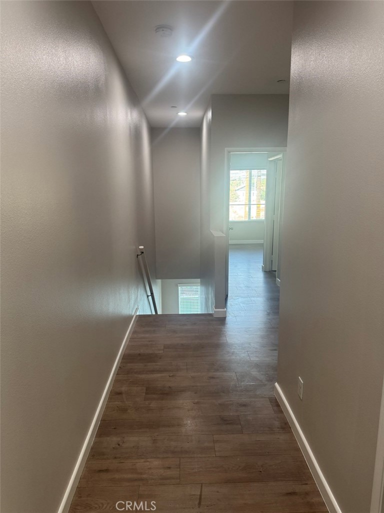 13665 Arrow Route, Unit 6 Fontana, CA 92335 - Photo 30 of 42 an empty room with wooden floor and windows