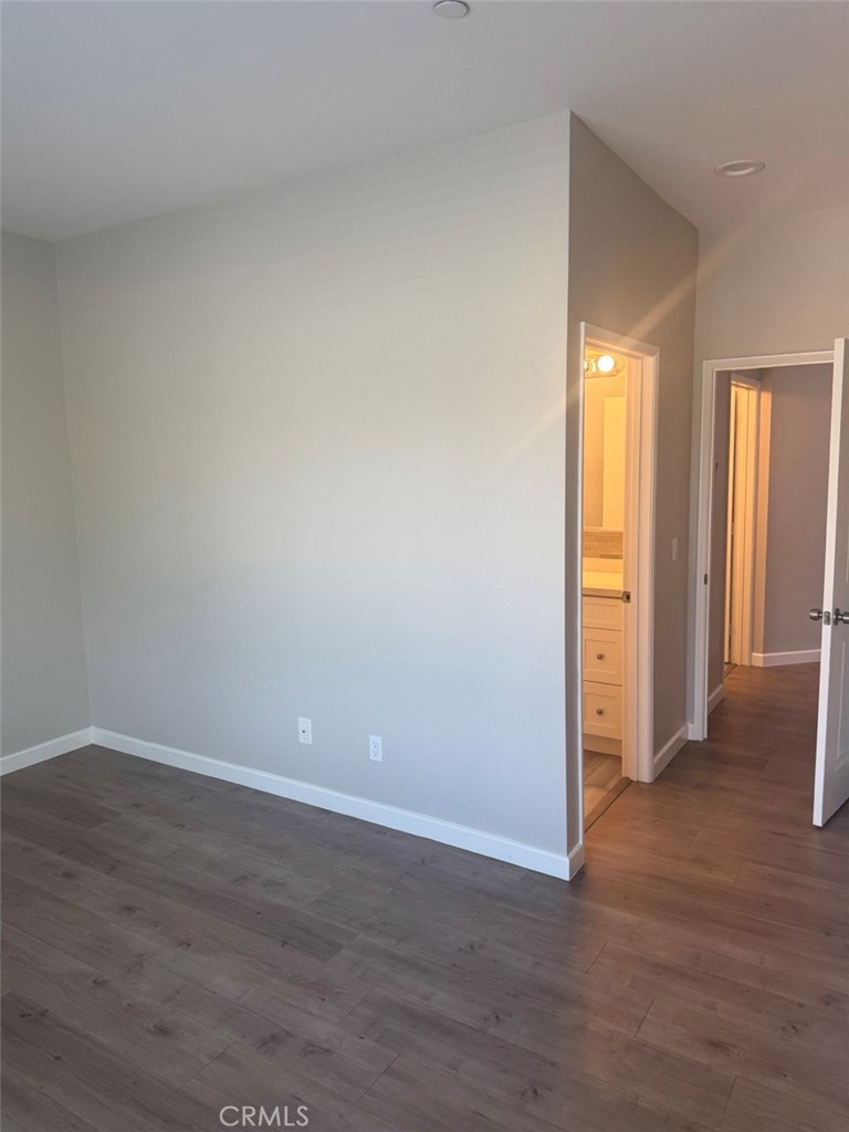 13665 Arrow Route, Unit 6 Fontana, CA 92335 - Photo 38 of 42 a view of an empty room with wooden floor and closet