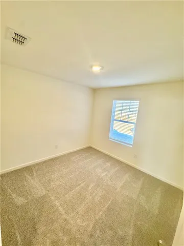 an empty room with a empty space and window