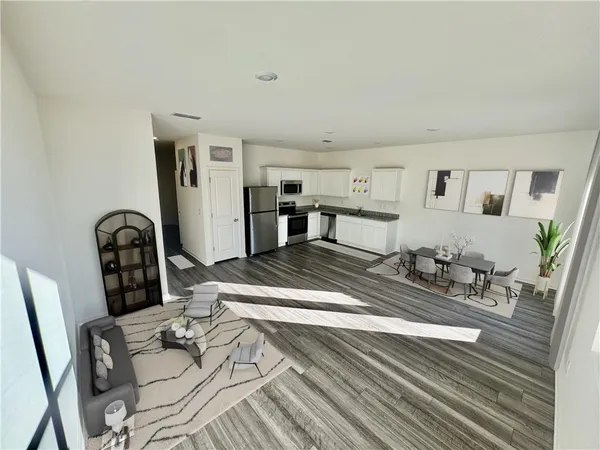 a living room with furniture a dining table and wooden floor