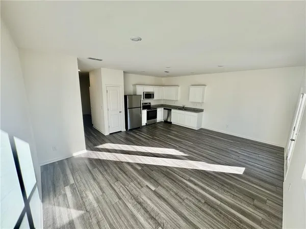 a view of a kitchen with wooden floor