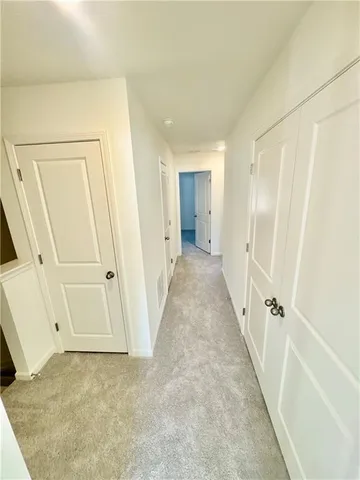 a view of a hallway with white walls