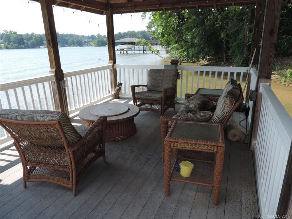 5516 Plantation Ridge Road Charlotte, NC 28214 - Photo 11 of 24 a balcony with wooden floor outdoor seating and yard in the back