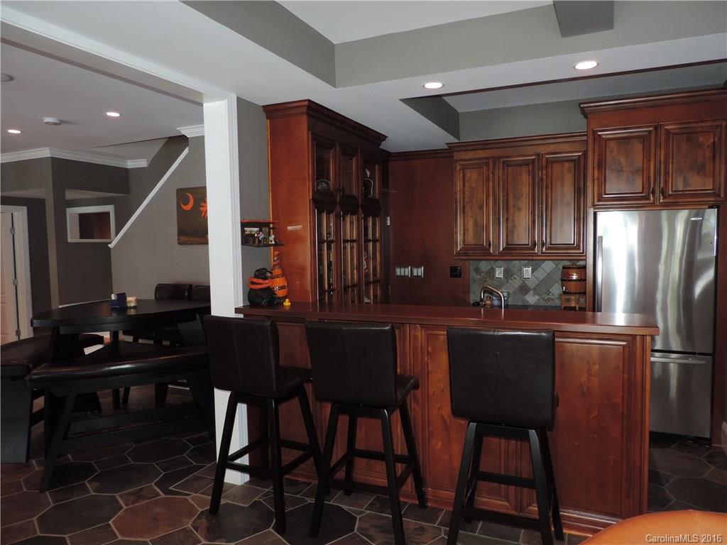 5516 Plantation Ridge Road Charlotte, NC 28214 - Photo 13 of 24 a kitchen with stainless steel appliances kitchen island granite countertop a refrigerator a stove a sink dishwasher and a dining table with wooden floor