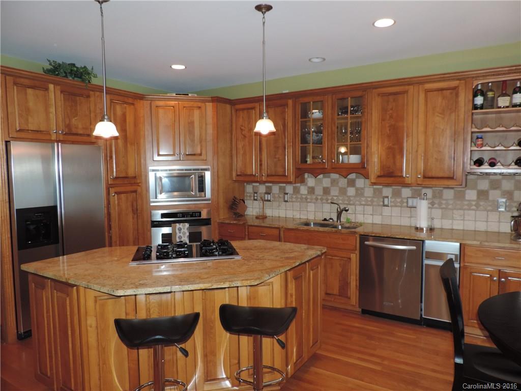 5516 Plantation Ridge Road Charlotte, NC 28214 - Photo 19 of 24 a kitchen with stainless steel appliances granite countertop a sink a stove a refrigerator cabinets and chairs
