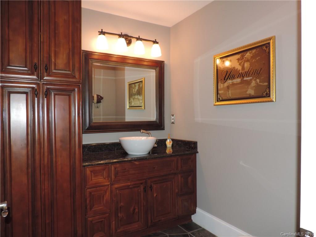 5516 Plantation Ridge Road Charlotte, NC 28214 - Photo 23 of 24 a bathroom with a granite countertop sink and a mirror