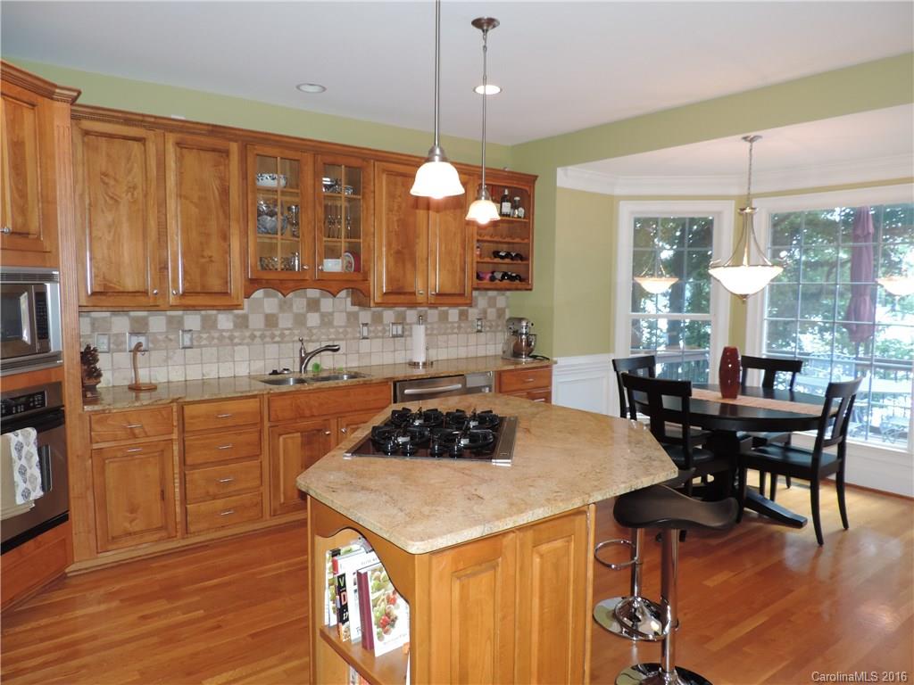 5516 Plantation Ridge Road Charlotte, NC 28214 - Photo 4 of 24 a kitchen with a table chairs stove and cabinets