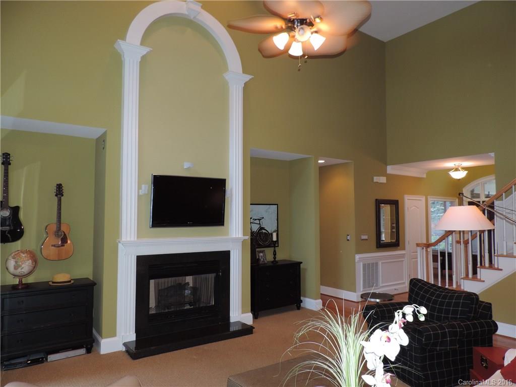 5516 Plantation Ridge Road Charlotte, NC 28214 - Photo 5 of 24 a living room with furniture a flat screen tv and a fireplace