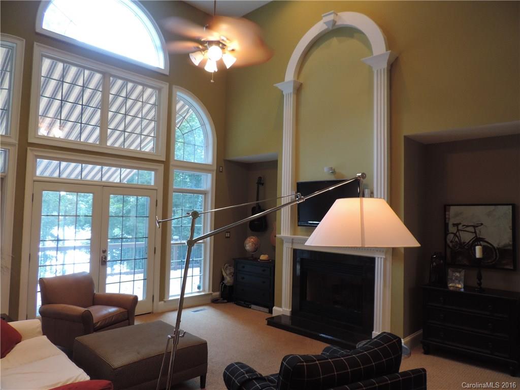 5516 Plantation Ridge Road Charlotte, NC 28214 - Photo 6 of 24 a living room with a furniture a chandelier and a fireplace