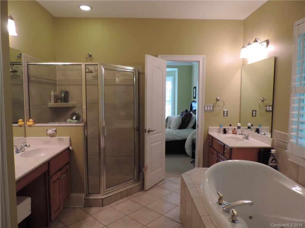 5516 Plantation Ridge Road Charlotte, NC 28214 - Photo 7 of 24 a bathroom with a tub a sink and mirror