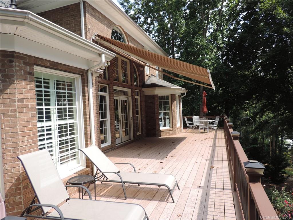 5516 Plantation Ridge Road Charlotte, NC 28214 - Photo 9 of 24 a view of a patio with table and chairs with wooden floor and fence