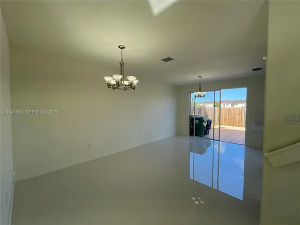 a view of kitchen with stainless steel appliances refrigerator oven and cabinets