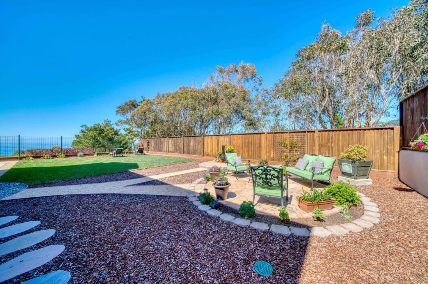 1 Connemara Drive Pacifica, CA 94044 - Photo 12 of 45 a backyard of a house with yard and outdoor seating