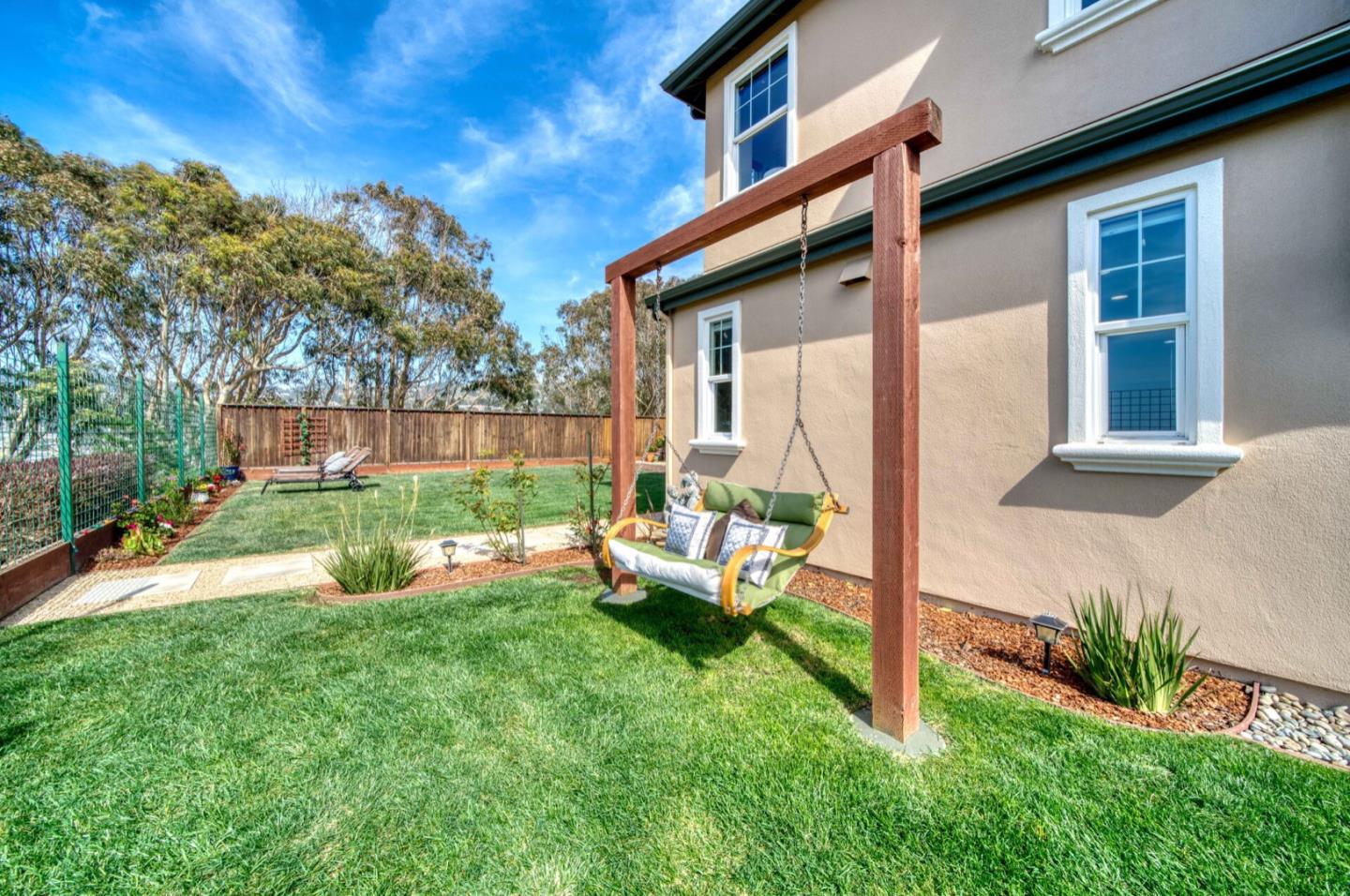1 Connemara Drive Pacifica, CA 94044 - Photo 13 of 45 a view of a house with backyard sitting area and garden