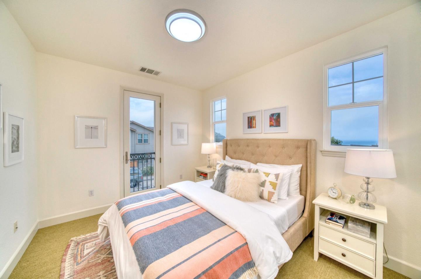 1 Connemara Drive Pacifica, CA 94044 - Photo 18 of 45 a bedroom with a bed and a lamp