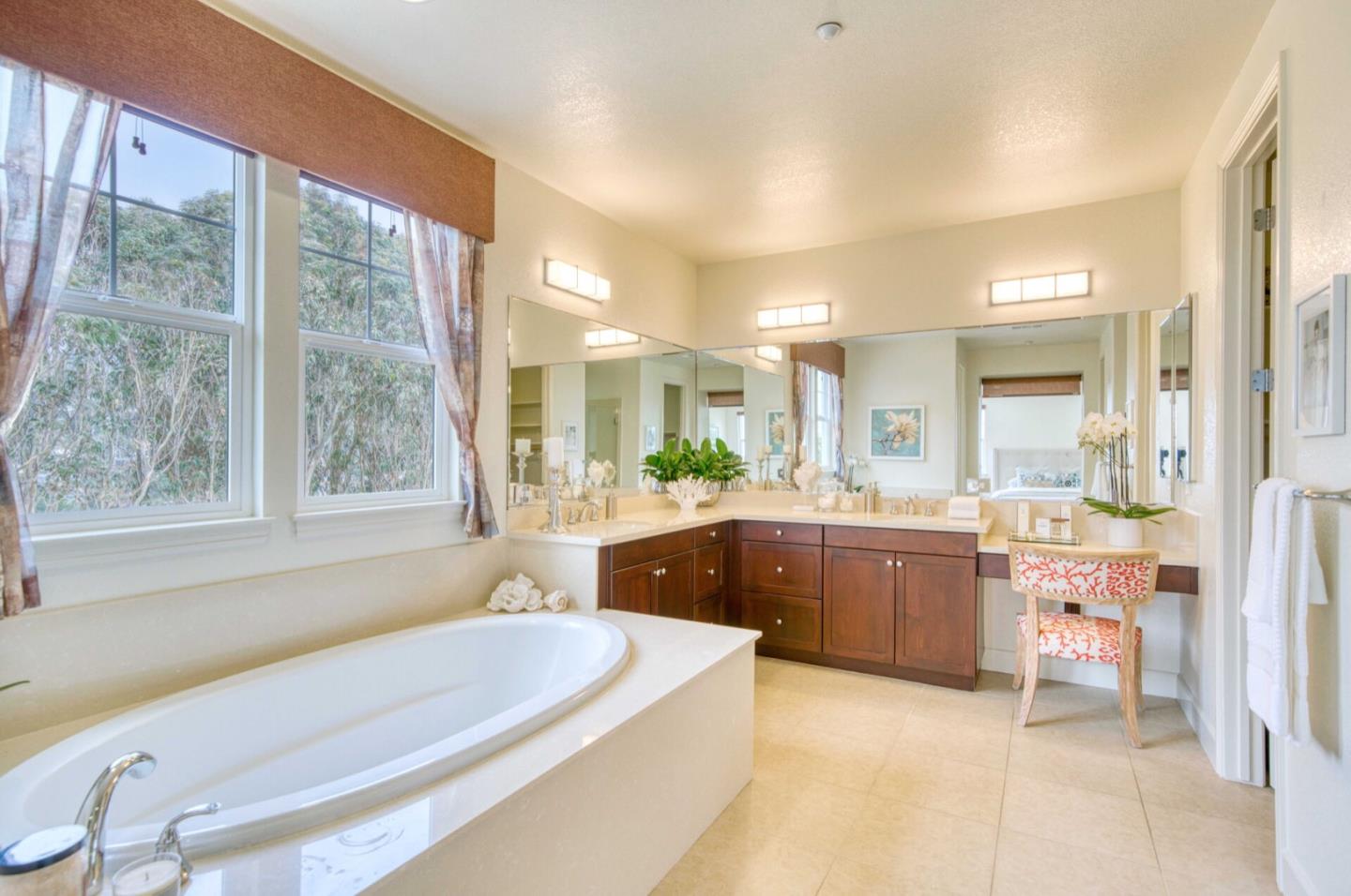 1 Connemara Drive Pacifica, CA 94044 - Photo 25 of 45 a bathroom with a granite countertop tub sink and mirror