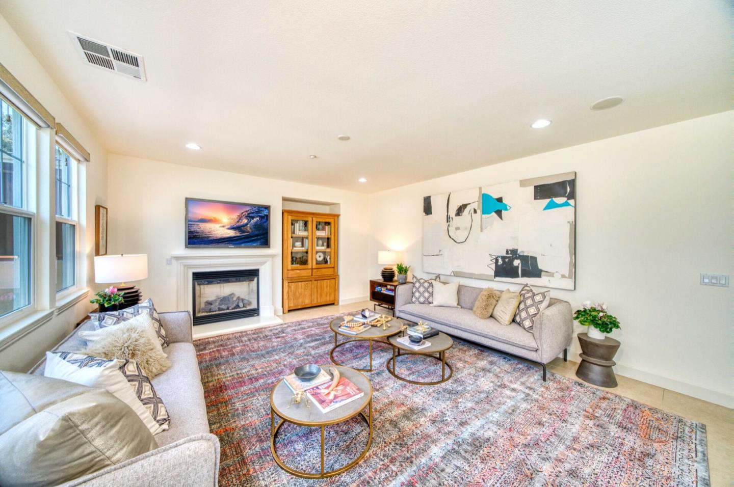1 Connemara Drive Pacifica, CA 94044 - Photo 9 of 45 a living room with furniture a fireplace and a flat screen tv