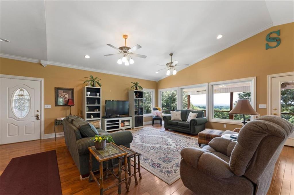 300 Ellis Road Southeast Rome, GA 30161 - Photo 11 of 46 a living room with furniture a large window and a dining table
