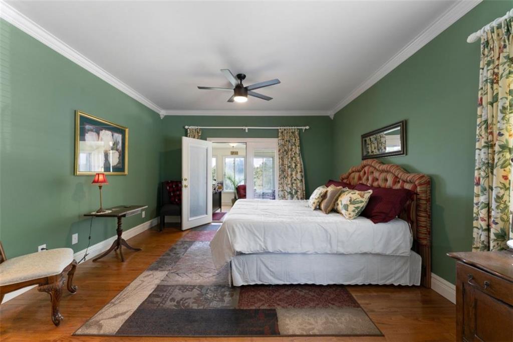 300 Ellis Road Southeast Rome, GA 30161 - Photo 25 of 46 a bedroom with a large bed chandelier and a window