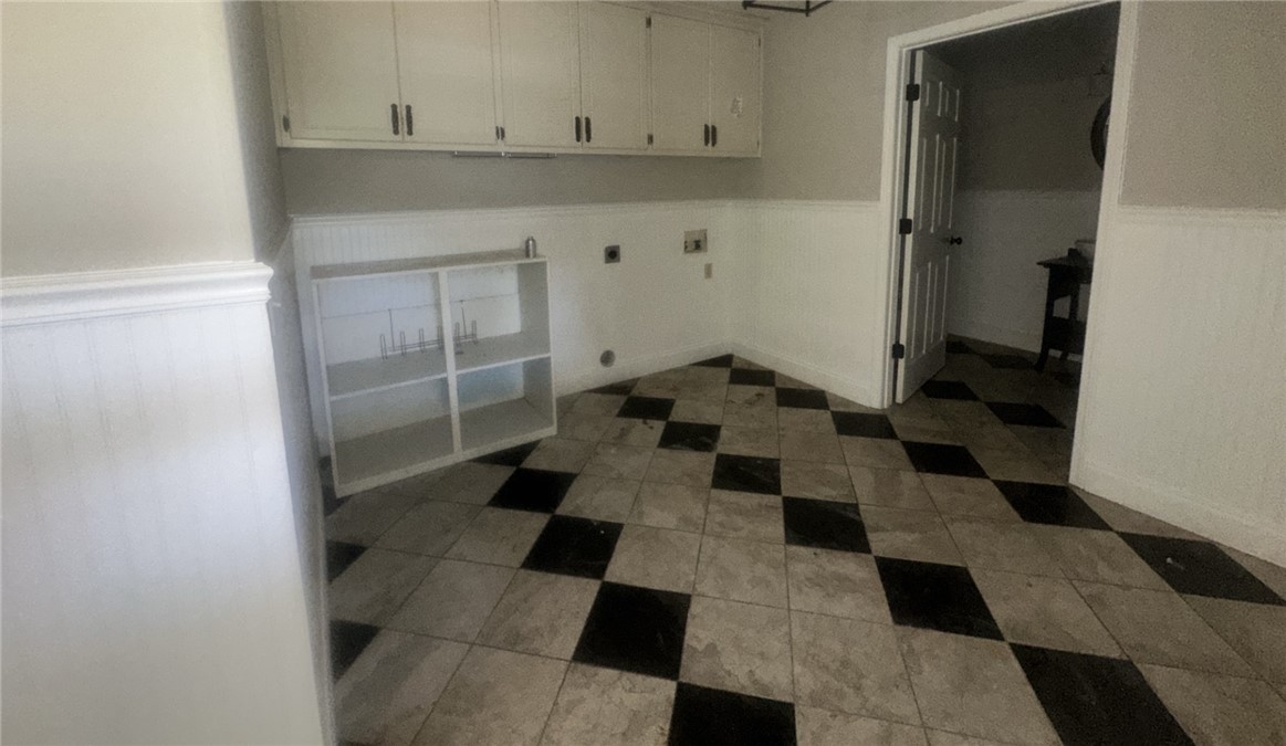 115 Mountain Springs Road West Union, SC 29696 - Photo 13 of 17 Classic checkerboard tile flooring and built-in cabinetry define this functional utility space.