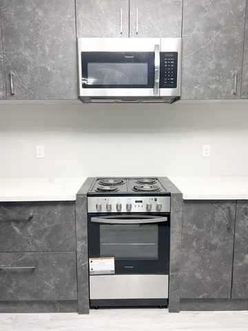 a stove top oven sitting inside of a kitchen