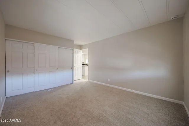 a view of an empty room and closet area