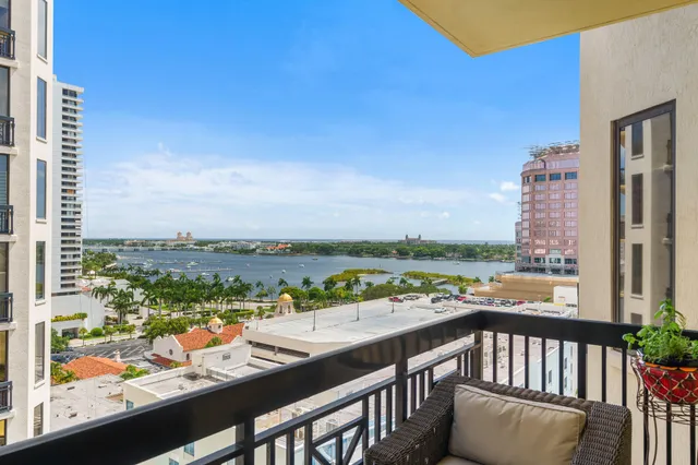 a living room with furniture a table and a large window