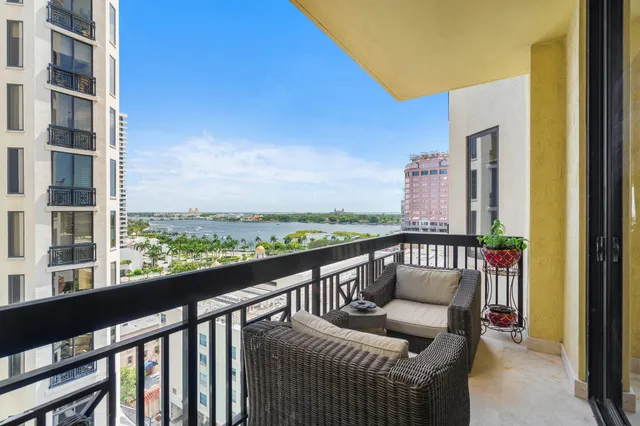 a living room with furniture a large window and a flat screen tv