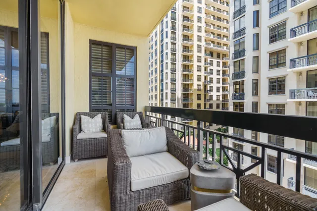 a living room with furniture a chandelier and a large mirror