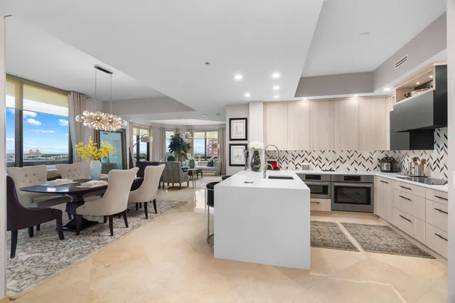 a kitchen with stainless steel appliances kitchen island granite countertop a sink and cabinets