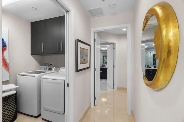 a bedroom with a bed mirror and painting on the wall