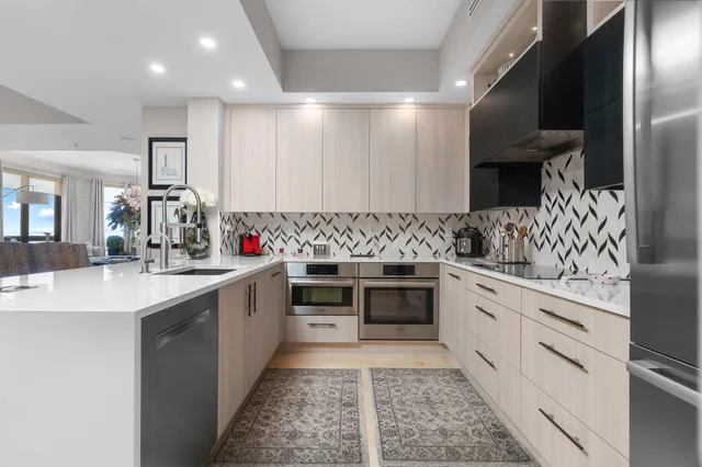 a kitchen with kitchen island a counter top space appliances and cabinets