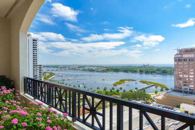 a view of a balcony with flower plants