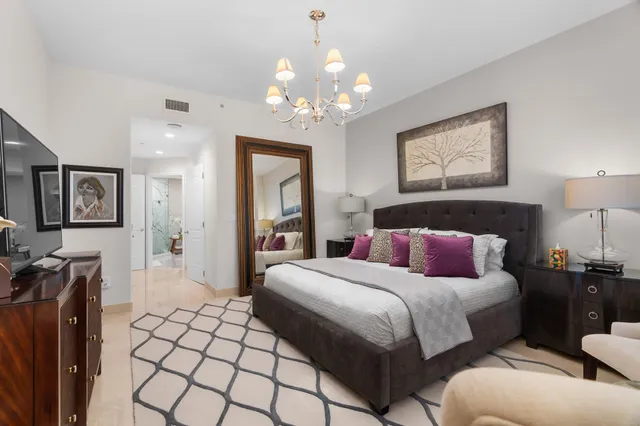 a bedroom with a bed and lamp