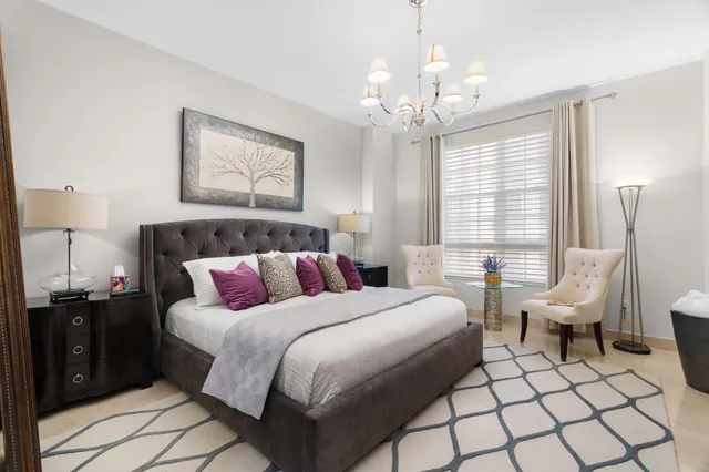 a bedroom with a bed and a mirror