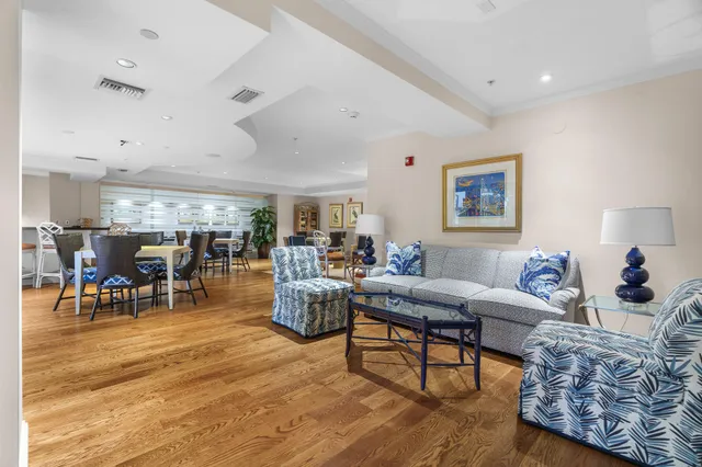 a living room with furniture a table and a potted plant