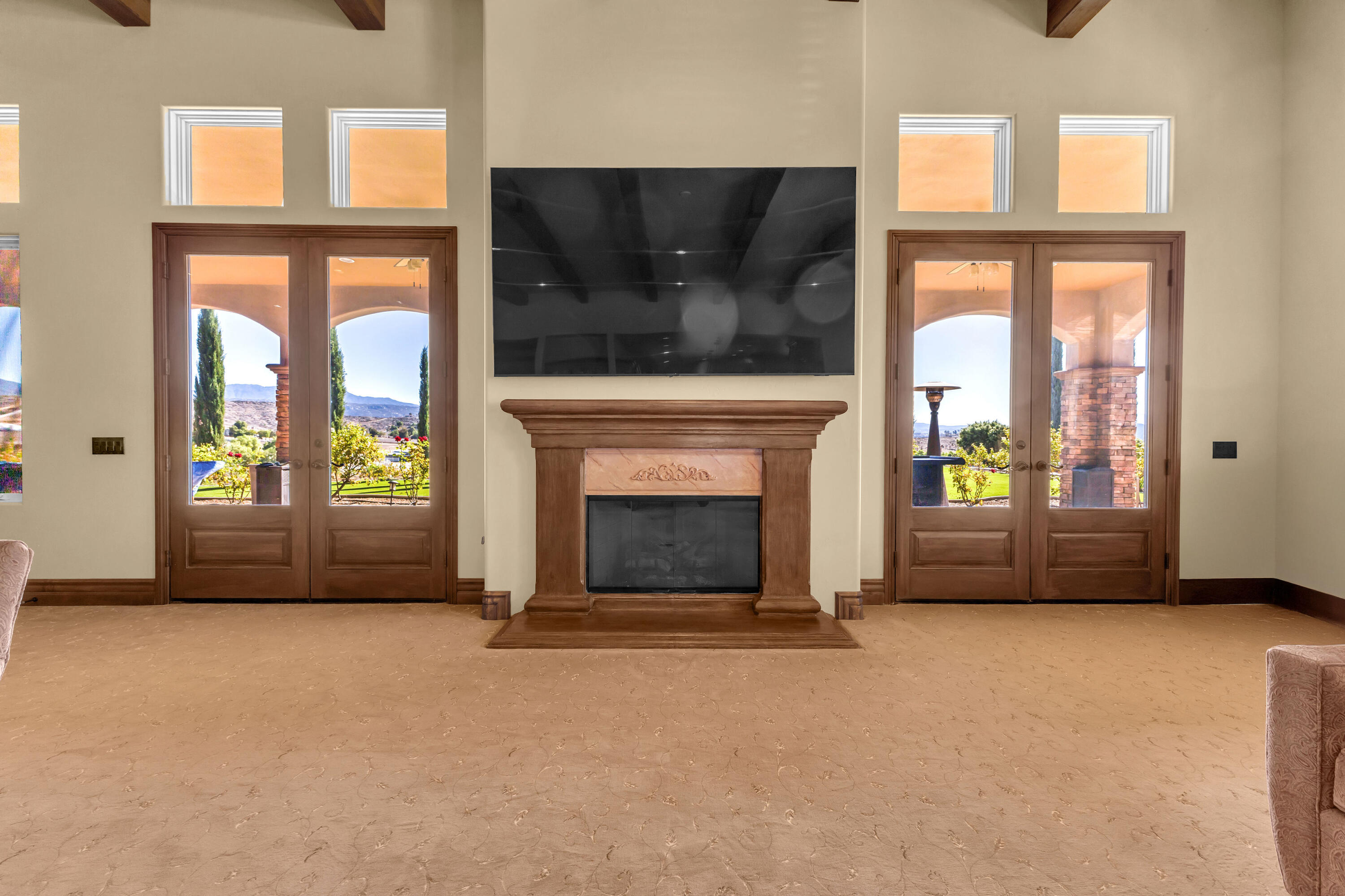 39345 San Ignacio Road Hemet, CA 92544 - Photo 22 of 110 a living room with a fireplace and a large window