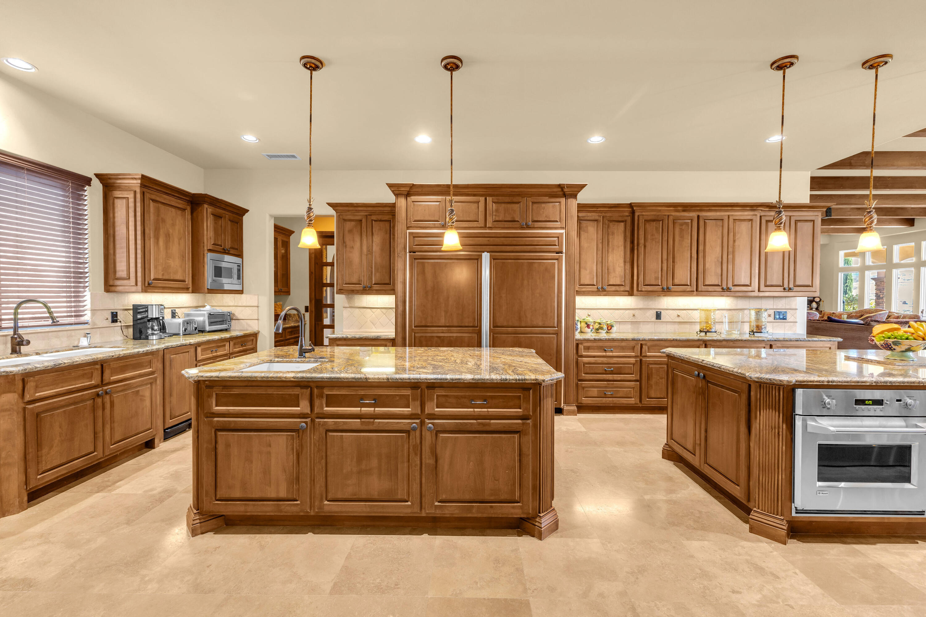 39345 San Ignacio Road Hemet, CA 92544 - Photo 29 of 110 a kitchen with kitchen island granite countertop a sink counter top space appliances and a cabinets