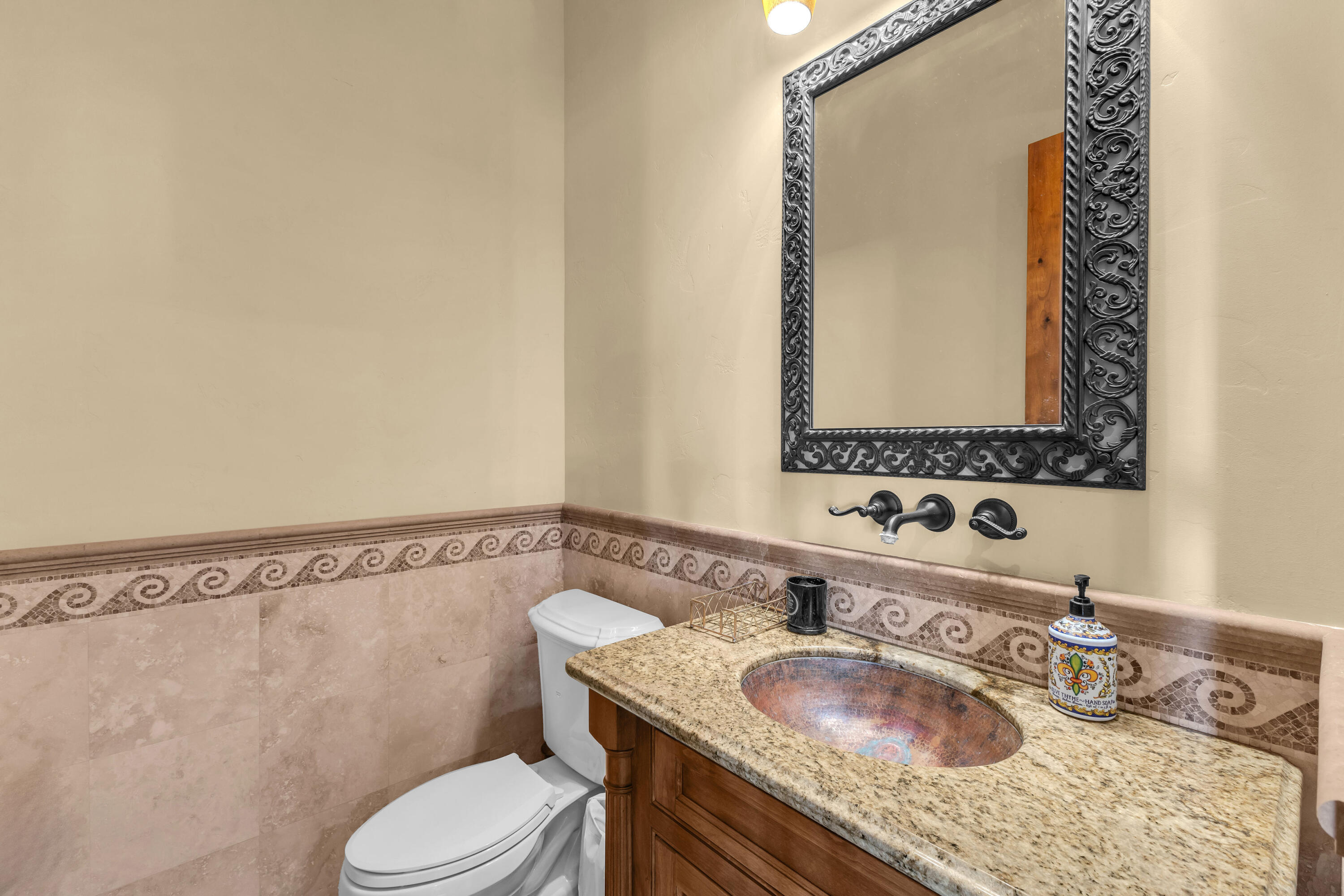 39345 San Ignacio Road Hemet, CA 92544 - Photo 36 of 110 a bathroom with a granite countertop sink vanity mirror and toilet