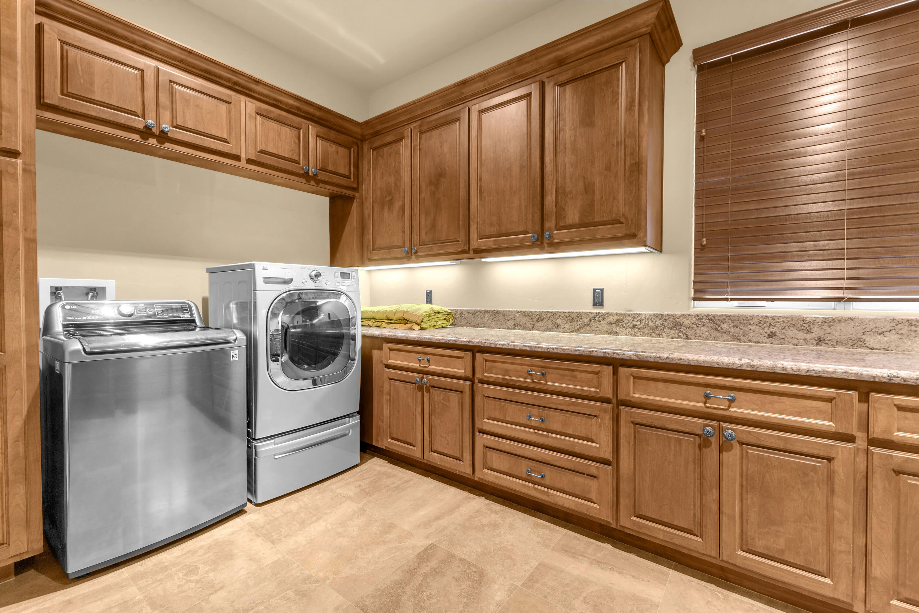 39345 San Ignacio Road Hemet, CA 92544 - Photo 59 of 110 a kitchen with granite countertop a sink and a refrigerator