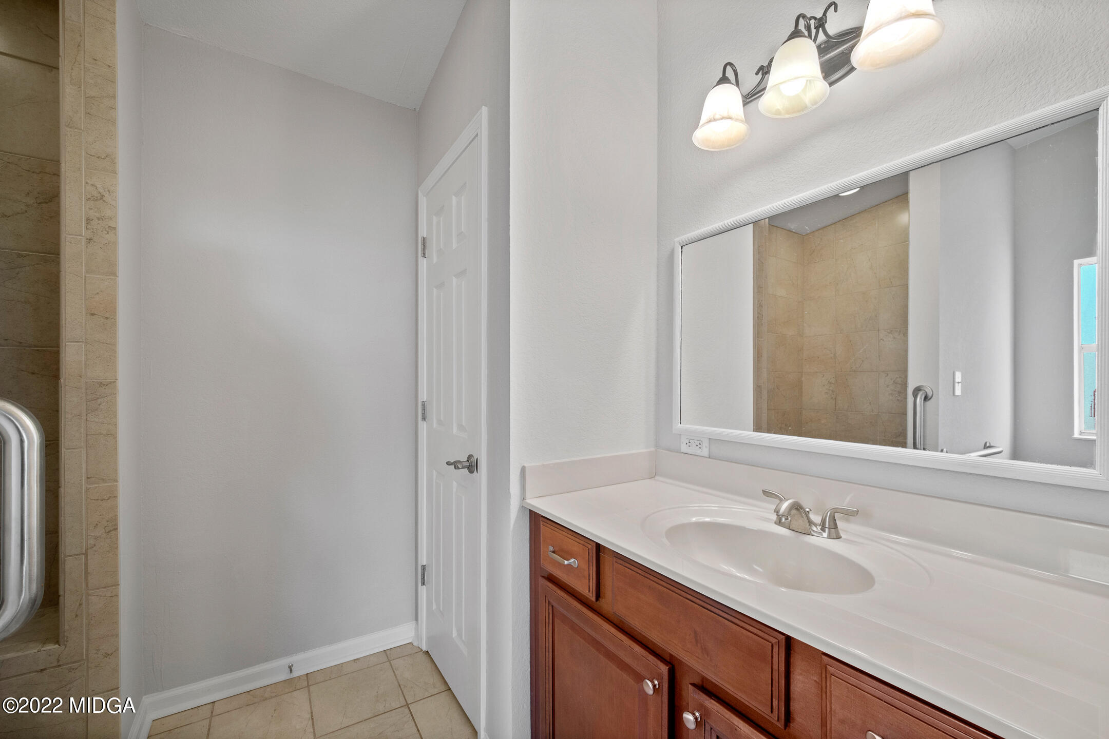 170 Arrow Point Road Jackson, GA 30233 - Photo 15 of 37 a bathroom with a sink a mirror and a shower