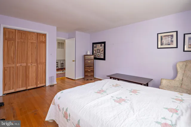 a bedroom with a bed and cabinets
