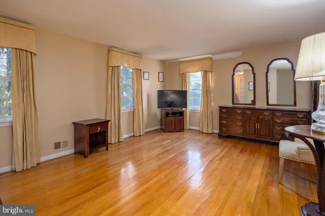 a view of a livingroom with furniture hardwood floor and a window