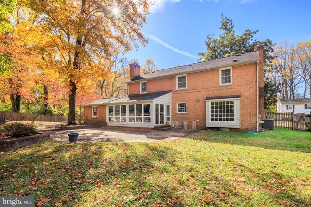 a view of a yard in front of a house with a large tree
