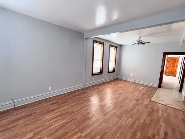 wooden floor in an empty room with a window