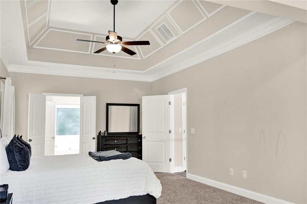 407 Corinth Church Road Winder, GA 30680 - Photo 35 of 66 a room with a bed and a chandelier