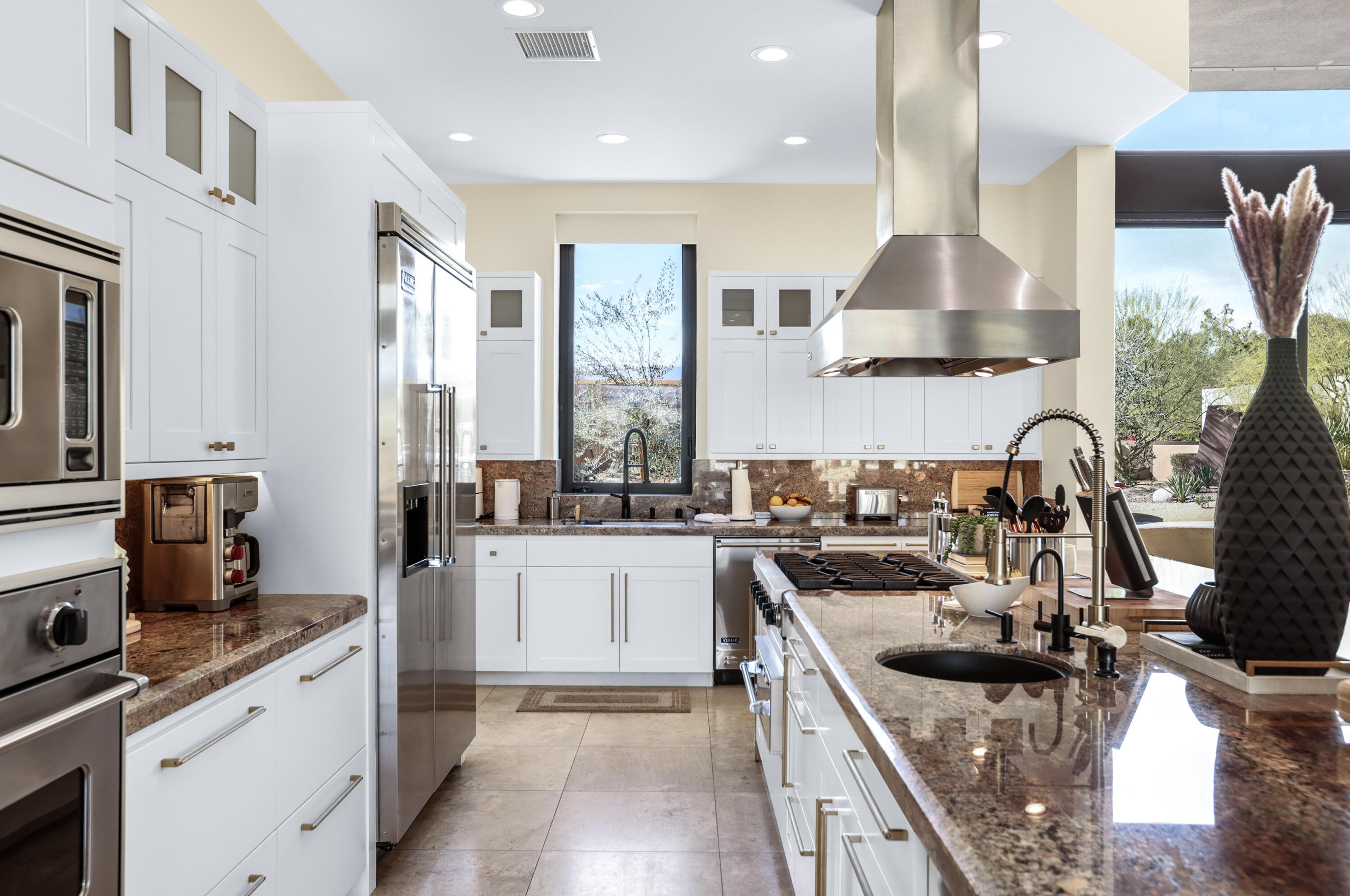 1 Seclude Court Rancho Mirage, CA 92270 - Photo 22 of 52 a kitchen with stainless steel appliances granite countertop a sink stove and refrigerator