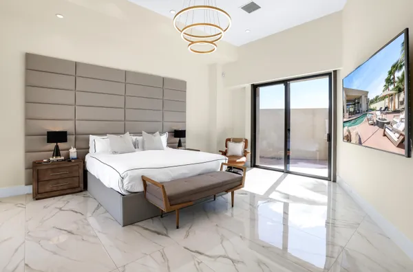 a bedroom with a bed and a chair in it