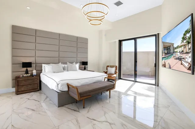 a bedroom with a bed and a chair in it