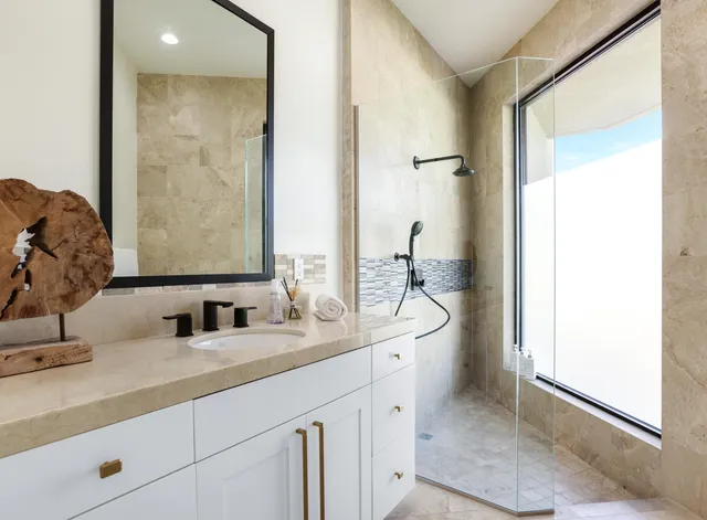 a bathroom with a toilet sink shower and mirror